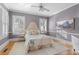 Cozy bedroom with hardwood floors, a plush bed, plantation shutters, and neutral decor at 615 Collier Nw Rd, Atlanta, GA 30318