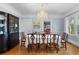 Formal dining room featuring hardwood floors, a large china cabinet, and a chandelier at 615 Collier Nw Rd, Atlanta, GA 30318