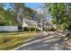 Quaint home showcasing a manicured lawn, mature trees, and a private driveway at 615 Collier Nw Rd, Atlanta, GA 30318