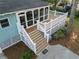 Back of house showing elevated porch, stairs, and deck with surrounding trees at 615 Collier Nw Rd, Atlanta, GA 30318