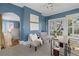 Comfortable home office showcasing natural light and an adjacent sitting area at 615 Collier Nw Rd, Atlanta, GA 30318