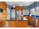 Kitchen featuring stainless steel appliances, a kitchen island, wooden cabinets, and blue wallpaper at 615 Collier Nw Rd, Atlanta, GA 30318
