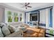 Sun-drenched living room with hardwood floors and modern furniture, great natural light and curtains at 615 Collier Nw Rd, Atlanta, GA 30318