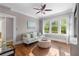 Comfortable living room with hardwood floors and neutral color scheme, features a sofa and ottoman at 615 Collier Nw Rd, Atlanta, GA 30318