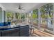 Relaxing screened-in porch with a swing, furniture, and views of the green outdoors at 615 Collier Nw Rd, Atlanta, GA 30318