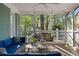 Well-furnished screened porch with comfortable blue sofa and traditional porch swing at 615 Collier Nw Rd, Atlanta, GA 30318