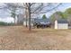 Spacious backyard with mature trees, shed, and a deck, creating an ideal space for relaxation and entertainment at 1195 Braselton Hwy, Lawrenceville, GA 30043