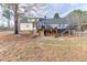 View of backyard showing deck, patio, basement access, and fenced yard at 1195 Braselton Hwy, Lawrenceville, GA 30043