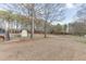 Large, fenced backyard with trees and shed, providing a private and serene outdoor space at 1195 Braselton Hwy, Lawrenceville, GA 30043