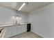 A functional basement space featuring white cabinets, a sink, and modern lighting fixtures at 1195 Braselton Hwy, Lawrenceville, GA 30043