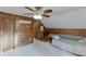 A comfortable bedroom showcasing a wood paneled wall and a ceiling fan at 1195 Braselton Hwy, Lawrenceville, GA 30043