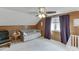 Cozy bedroom features a wood paneled wall, a ceiling fan, and a twin-sized bed at 1195 Braselton Hwy, Lawrenceville, GA 30043