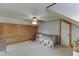 A spacious bedroom featuring a ceiling fan and a wood paneled accent wall at 1195 Braselton Hwy, Lawrenceville, GA 30043
