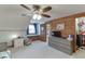 Lovely bedroom with wood-paneled walls, adjacent to a walk-in closet, and equipped with a window seat at 1195 Braselton Hwy, Lawrenceville, GA 30043