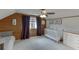 A delightful bedroom featuring wood paneled walls, a ceiling fan, and playful Dr. Seuss themed décor at 1195 Braselton Hwy, Lawrenceville, GA 30043