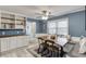 Dining area featuring built-in bench, stylish lighting, and views to a kitchen with granite counters at 1195 Braselton Hwy, Lawrenceville, GA 30043