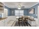 Cozy dining area with bench seating, decorative pillows, stylish lighting, and granite counters in the kitchen at 1195 Braselton Hwy, Lawrenceville, GA 30043