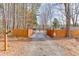 Gated driveway entrance providing added security to the property with a fenced perimeter and trees at 1195 Braselton Hwy, Lawrenceville, GA 30043