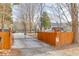 Long, gated driveway with wooden fence offering security and privacy to the home and property at 1195 Braselton Hwy, Lawrenceville, GA 30043