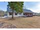 Quaint one-story home with front porch, complete with a green lawn and mature landscaping at 1195 Braselton Hwy, Lawrenceville, GA 30043