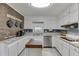Bright kitchen with granite counters, butcher block island, stainless appliances, and brick accent wall at 1195 Braselton Hwy, Lawrenceville, GA 30043
