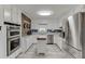Well-lit kitchen featuring stainless steel appliances, granite countertops, and white cabinetry with brick accents at 1195 Braselton Hwy, Lawrenceville, GA 30043