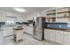 Bright kitchen features stainless steel appliances, white cabinets, granite counters and butcher block island at 1195 Braselton Hwy, Lawrenceville, GA 30043