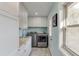 Bright laundry room with washer, dryer, white cabinets, and a butcher block countertop sink at 1195 Braselton Hwy, Lawrenceville, GA 30043