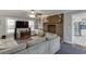 Inviting living room features a brick fireplace, ceiling fan, and comfortable seating with view into the kitchen at 1195 Braselton Hwy, Lawrenceville, GA 30043