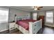 Cozy main bedroom with hardwood floors, a ceiling fan, dresser, and great natural light at 1195 Braselton Hwy, Lawrenceville, GA 30043