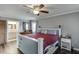 Cozy main bedroom features hardwood floors, a ceiling fan, and a connecting bathroom at 1195 Braselton Hwy, Lawrenceville, GA 30043