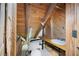 Rustic bathroom features wood paneled walls, wood beams, a toilet and vanity with a white sink at 1615 Hilltop Ct, Woodstock, GA 30188