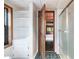 Bright bathroom featuring built-in shelves and an adjoining shower, with open doorway to a bedroom at 1615 Hilltop Ct, Woodstock, GA 30188