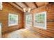 Inviting log cabin dining area with hardwood floors and bright, natural light from three windows at 1615 Hilltop Ct, Woodstock, GA 30188