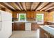 The kitchen of this home features granite countertops, wood walls, and plenty of natural light at 1615 Hilltop Ct, Woodstock, GA 30188