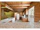 Rustic log cabin kitchen with granite countertops, wood cabinets and a bright window at 1615 Hilltop Ct, Woodstock, GA 30188