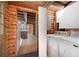 Log cabin laundry room with modern washer and dryer, opening to an adjacent room at 1615 Hilltop Ct, Woodstock, GA 30188