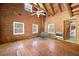 A living room featuring wood walls, wood beamed ceiling, and hardwood floors at 1615 Hilltop Ct, Woodstock, GA 30188