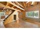 The living room features hardwood floors and a wooden beamed ceiling with a staircase to the left at 1615 Hilltop Ct, Woodstock, GA 30188