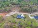 An aerial view of a home nestled among trees, surrounded by walking trails and green spaces at 3078 Turning Creek Trl, Dacula, GA 30019