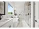 A spa-like bathroom has a soaking tub, a glass shower, double vanity sinks, and marble floors at 3078 Turning Creek Trl, Dacula, GA 30019