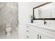 Bathroom with single sink vanity with marble countertop and walk-in shower at 3078 Turning Creek Trl, Dacula, GA 30019