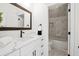 Bathroom with single sink vanity, marble countertop and walk-in shower at 3078 Turning Creek Trl, Dacula, GA 30019