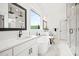 A spa-like bathroom with marble floors, a soaking tub, double vanity sinks, and a glass shower at 3078 Turning Creek Trl, Dacula, GA 30019