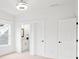 Clean bedroom with white walls, a doorway to the bathroom and closet, and a view of the front yard at 3078 Turning Creek Trl, Dacula, GA 30019