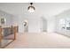 Spacious bonus room with large window and modern chandelier at 3078 Turning Creek Trl, Dacula, GA 30019