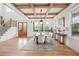 Bright dining room with wood floors, coffered ceiling, and a view of the backyard at 3078 Turning Creek Trl, Dacula, GA 30019