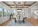 Inviting dining area with coffered ceiling, modern chandelier, and open kitchen view at 3078 Turning Creek Trl, Dacula, GA 30019