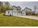 Modern home exterior showcasing a 3-car garage, white siding and an inviting covered porch at 3078 Turning Creek Trl, Dacula, GA 30019