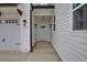 Close-up of a home's front entrance, complete with a white door, carriage lights, and clean siding at 3078 Turning Creek Trl, Dacula, GA 30019